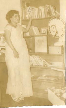 Iris Perera Stands By a B...