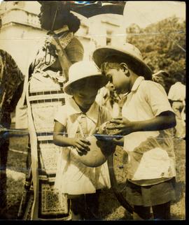 Two Children Drinking Water