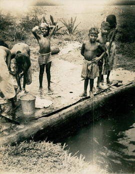 Women and Children Bathe ...