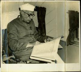 Mr. Nehru Reading a News ...